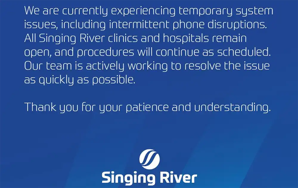 Screenshot of a Dec. 23 Singing River Facebook graphic stating there are temporary system issues and intermittent phone disruptions; clinics and hospitals remain open and scheduled procedures will continue.