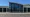 Front exterior of the Scottsboro Police Department building with the department name displayed across large glass windows.