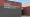 Exterior brick wall of the Saydel Community Schools District Office with large white lettering.
