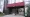 Glass doors at Everett City Hall’s Broadway entrance beneath a red awning marked 484.