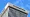 ConnectWise logo and lettering near the top of an office tower, viewed from below against a blue sky.