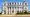 Cream-colored Vicksburg City Hall with a curved facade, white columns and two domed corner towers under a blue sky.