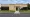 Front of the Weld Re-8 Administration Office, a tan brick building with large windows and a central entrance.